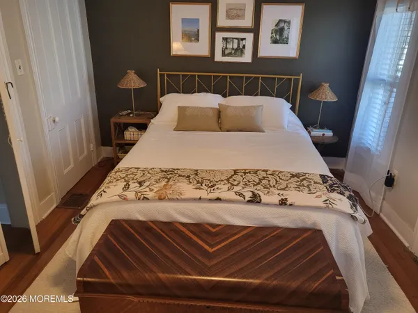 a bed sitting in a bedroom next to a window