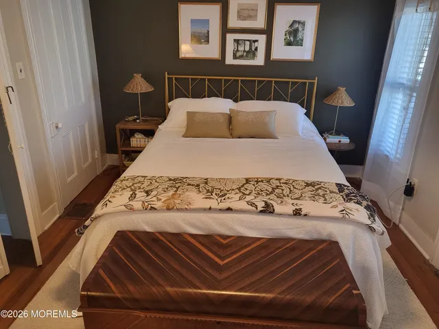 a bed sitting in a bedroom next to a window