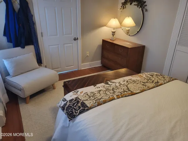a bedroom with a bed and a mirror