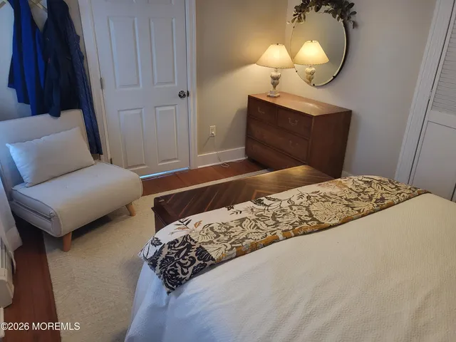 a bedroom with a bed and a mirror