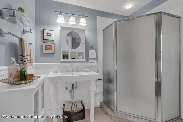 a bathroom with a mirror a sink and a shower