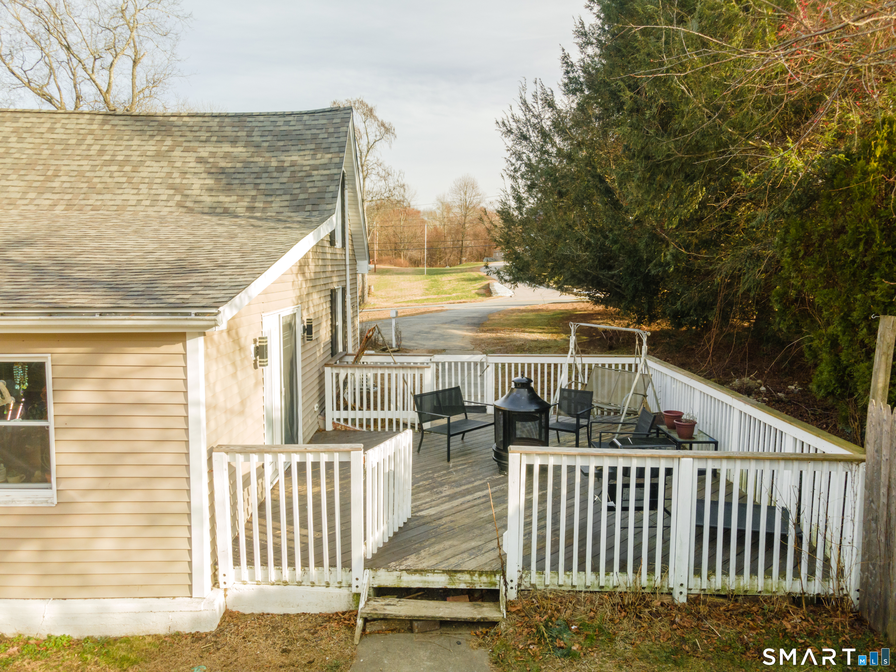 92 Hunters Avenue Norwich, CT 06380 - Photo 11 of 36 a view of a balcony with floor to ceiling window and wooden fence