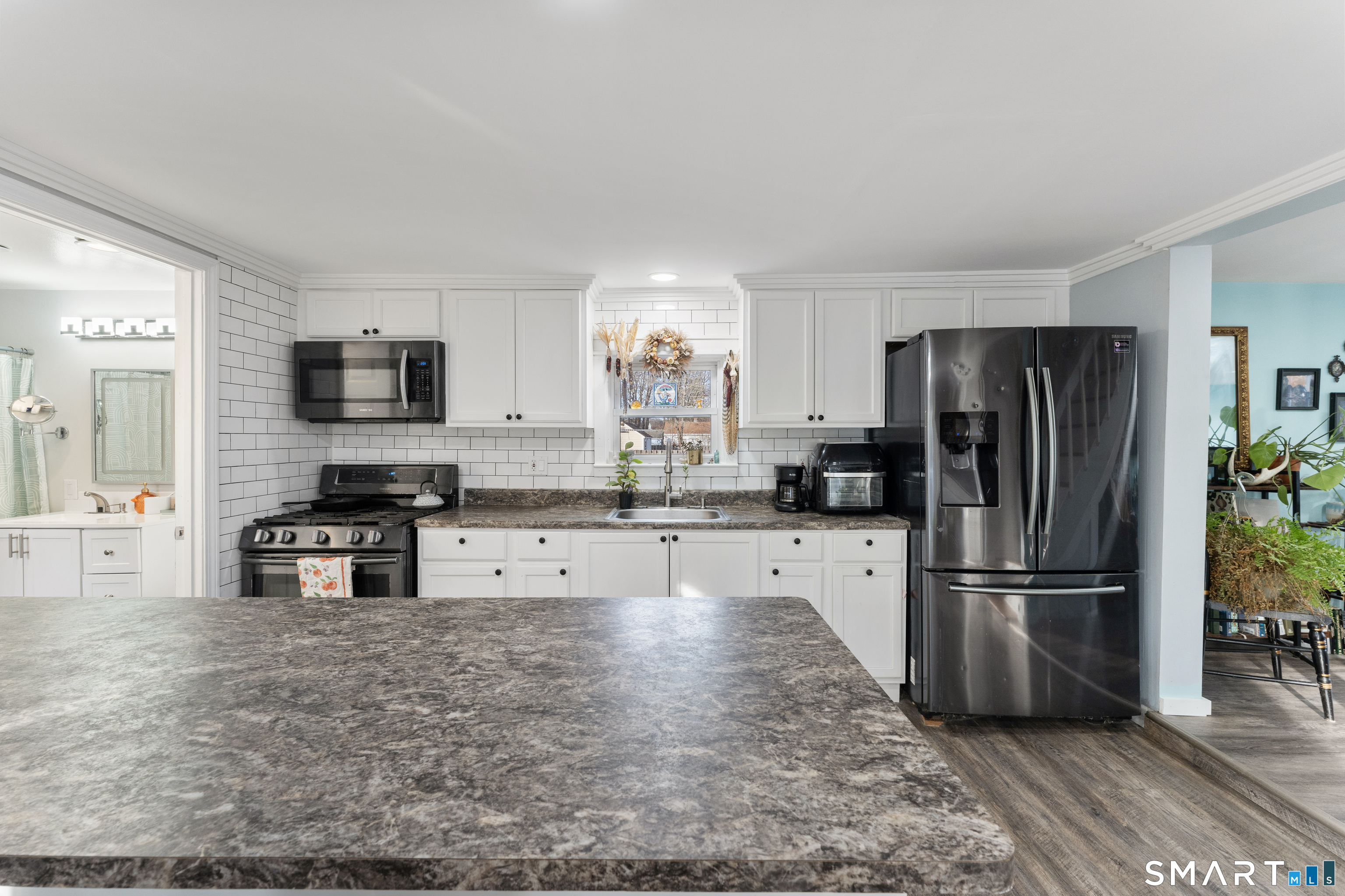 92 Hunters Avenue Norwich, CT 06380 - Photo 23 of 36 a kitchen with granite countertop a refrigerator and a stove top oven