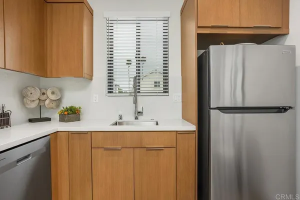 a kitchen with a refrigerator and a sink