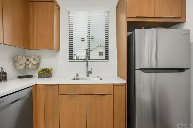 a kitchen with a refrigerator and a sink