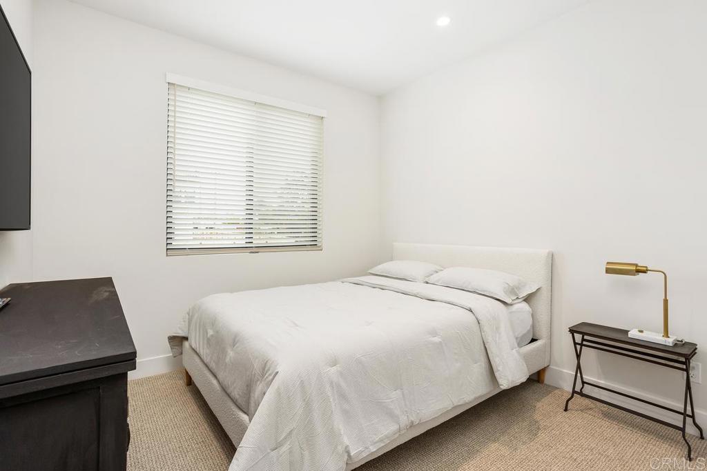 1756 Whaley Street Oceanside, CA 92054 - Photo 15 of 26 a bedroom with a bed and a window