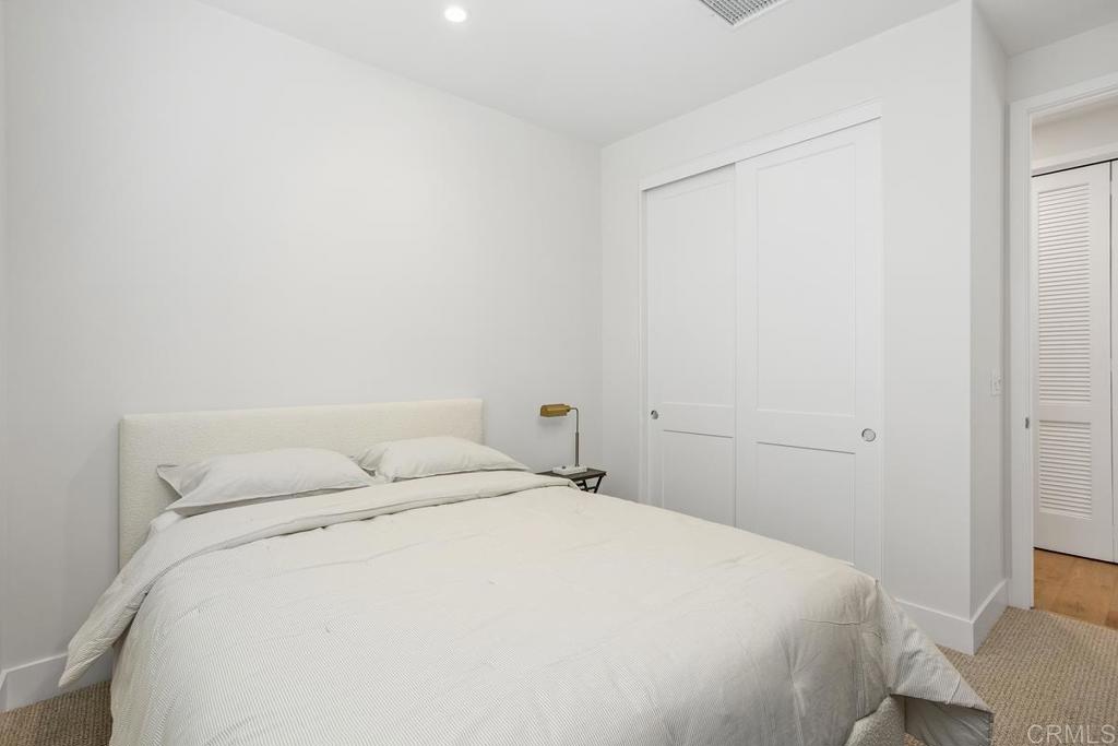 1756 Whaley Street Oceanside, CA 92054 - Photo 17 of 26 a bedroom with a bed and a window