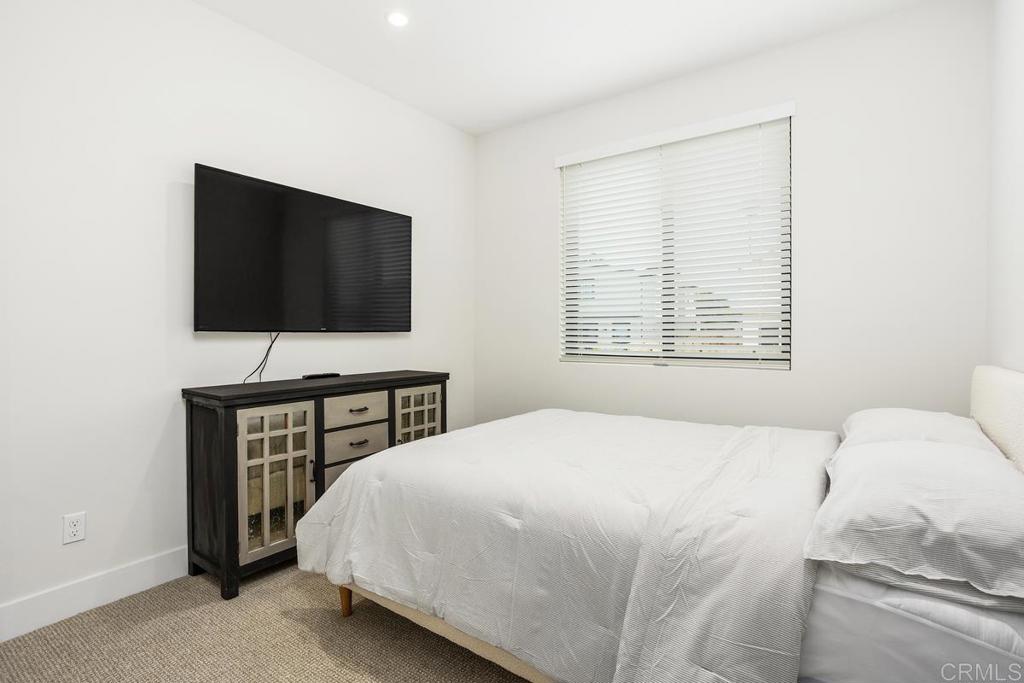 1756 Whaley Street Oceanside, CA 92054 - Photo 18 of 26 a bedroom with a bed and a flat screen tv