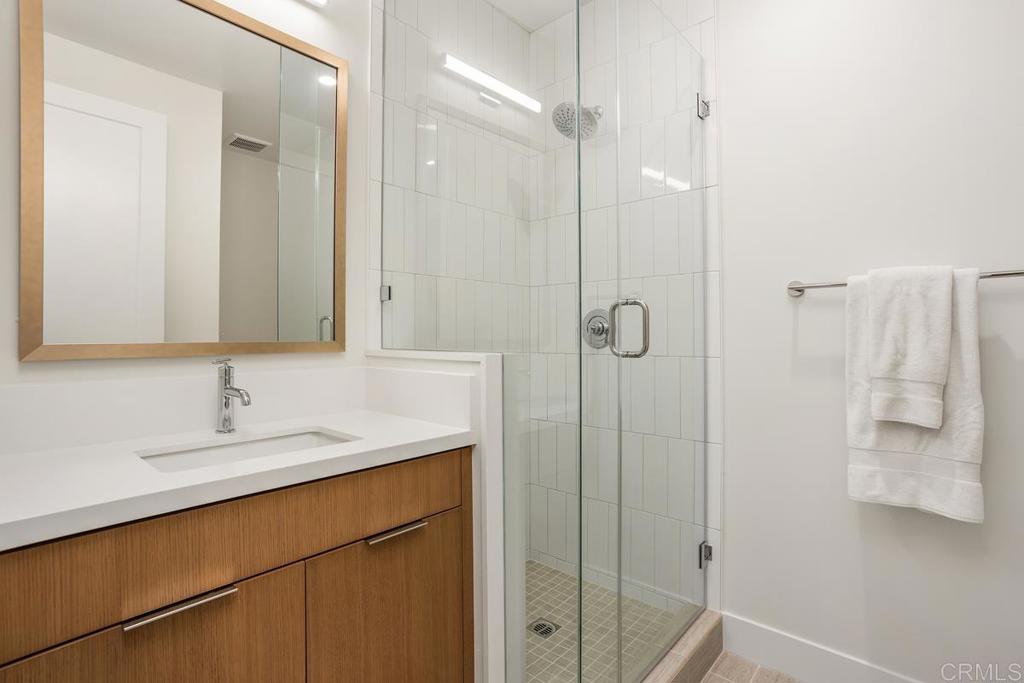 1756 Whaley Street Oceanside, CA 92054 - Photo 19 of 26 a bathroom with a sink and mirror