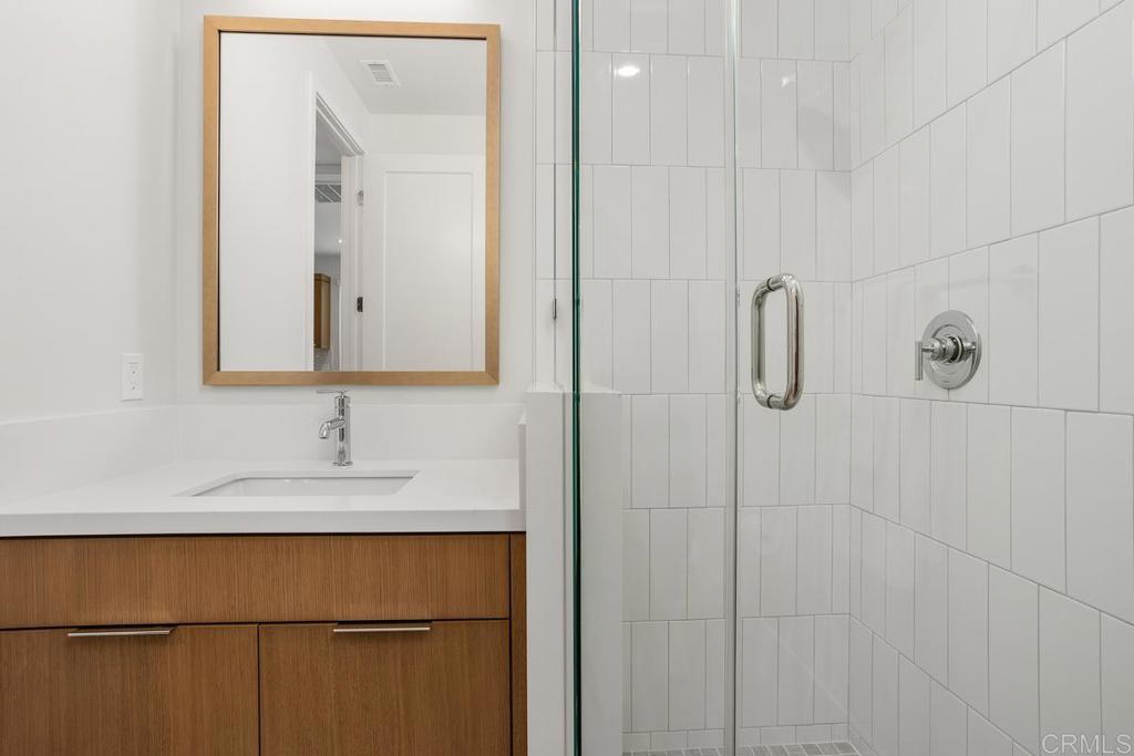 1756 Whaley Street Oceanside, CA 92054 - Photo 20 of 26 a bathroom with a sink and a mirror