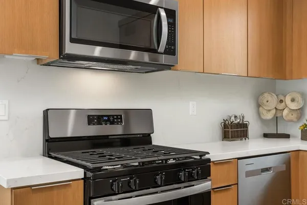 a stove top oven sitting inside of a kitchen
