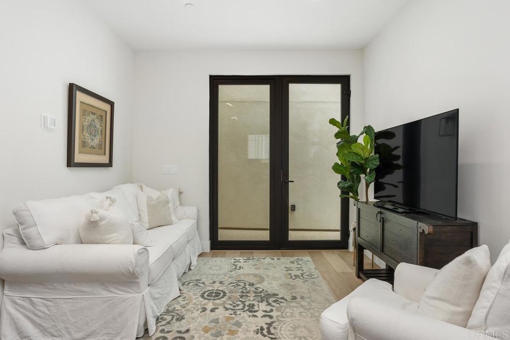 1756 Whaley Street Oceanside, CA 92054 - Photo 9 of 26 a living room with furniture and a flat screen tv