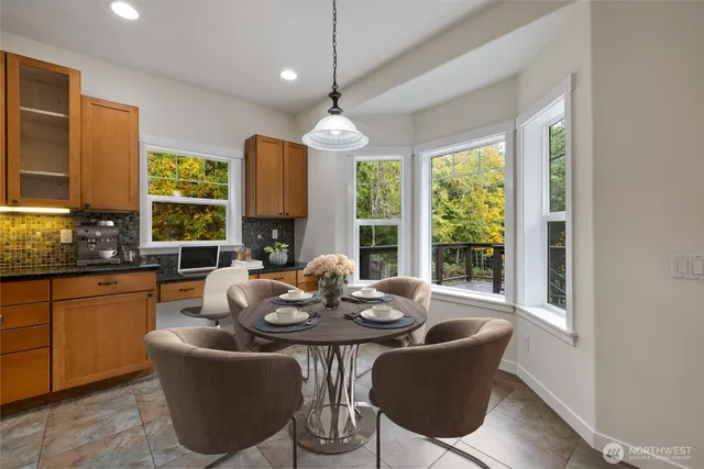 a dining room with furniture a chandelier and window