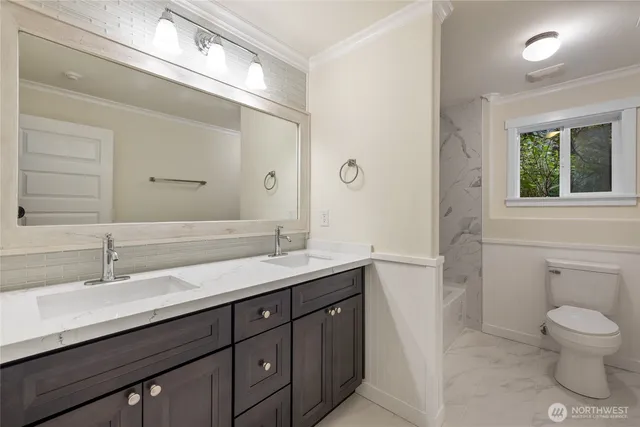 a bathroom with a granite countertop sink a toilet and a mirror