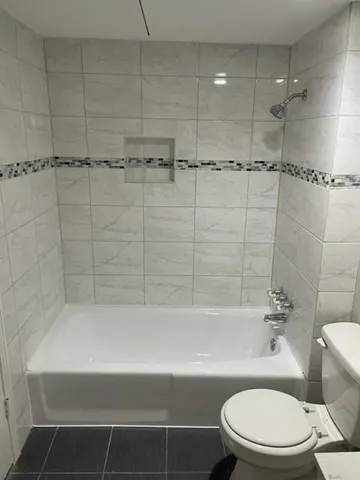 a bathroom with a toilet and shower