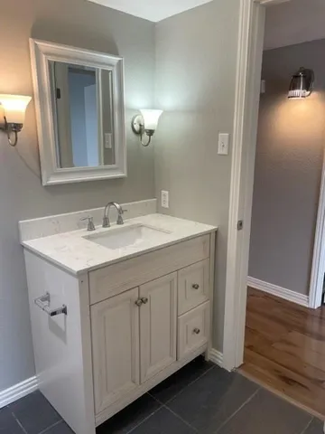 a bathroom with a sink and a mirror