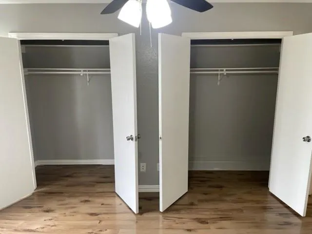 a view of empty room with wooden floor