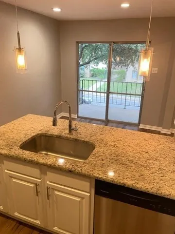 a kitchen with sink and window