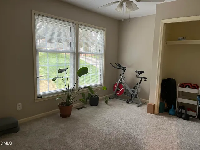 a view of a room with gym equipment and a window