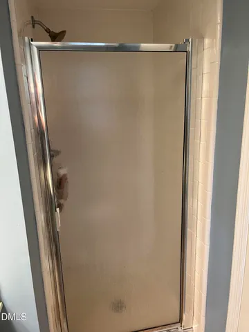 a bathroom with a glass shower door