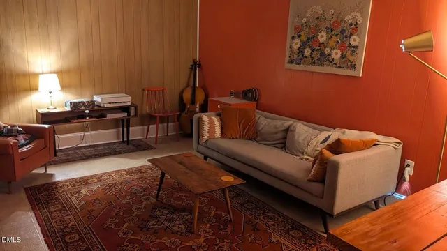 a living room with furniture and a lamp