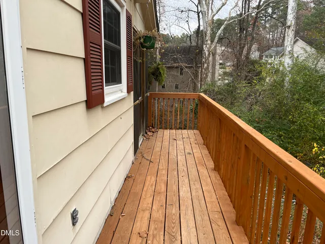 a view of balcony with wooden floor and fence