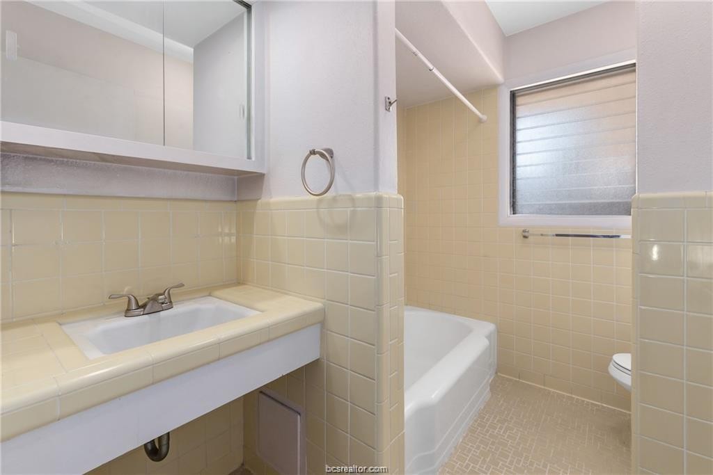 401 Helena Street Bryan, TX 77801 - Photo 19 of 21 a bathroom with a sink a toilet and shower