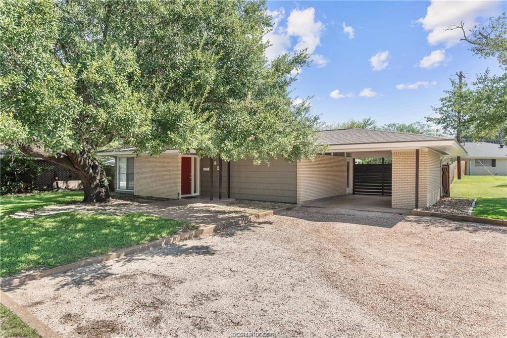 401 Helena Street Bryan, TX 77801 - Photo 2 of 21 a front view of a house with a yard and garage