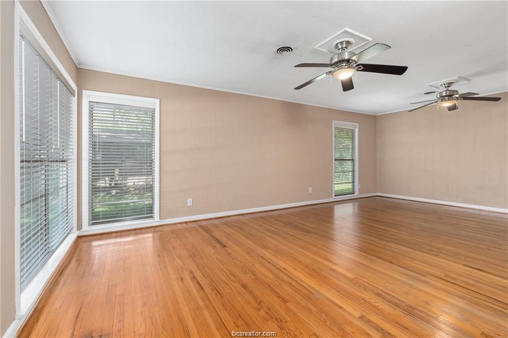 401 Helena Street Bryan, TX 77801 - Photo 7 of 21 a view of an empty room with wooden floor and a window