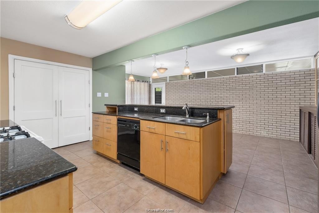 401 Helena Street Bryan, TX 77801 - Photo 8 of 21 a kitchen with stainless steel appliances granite countertop a sink and a stove