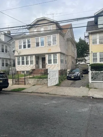 a front view of a residential apartment building with a yard