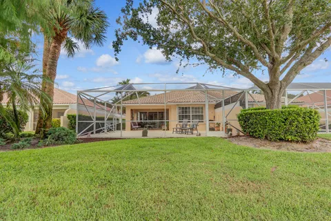 a view of a house with garden and trees