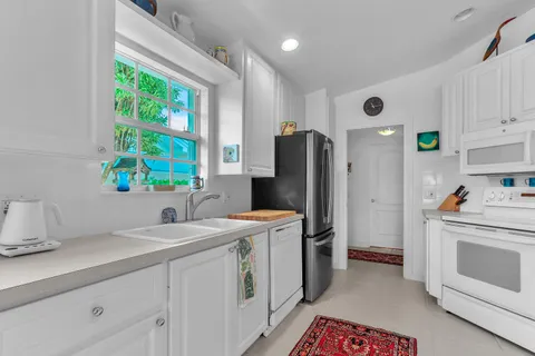 a kitchen with a sink a refrigerator and a stove