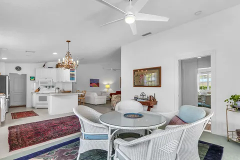 a living room with kitchen island furniture and a chandelier