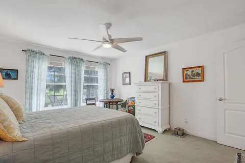 a bedroom with a bed and a large window