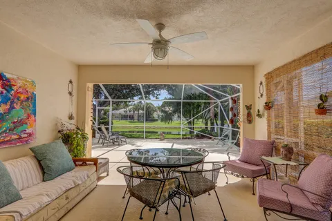 a living room with furniture and a floor to ceiling window