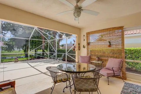 a backyard of a house with table and chairs