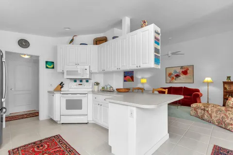 a kitchen with a sink cabinets and window