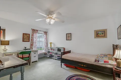 a bedroom with a bed a desk and chair