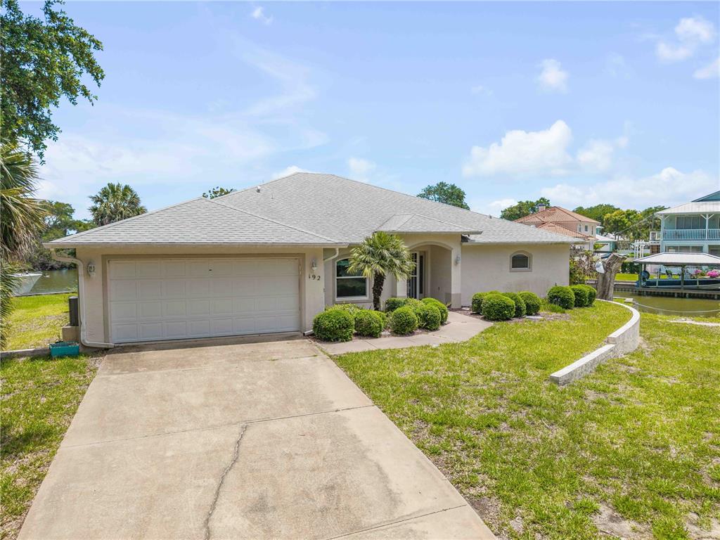 192 Azalea Road Edgewater, FL 32141 - Photo 60 of 94 a front view of house with yard and garage