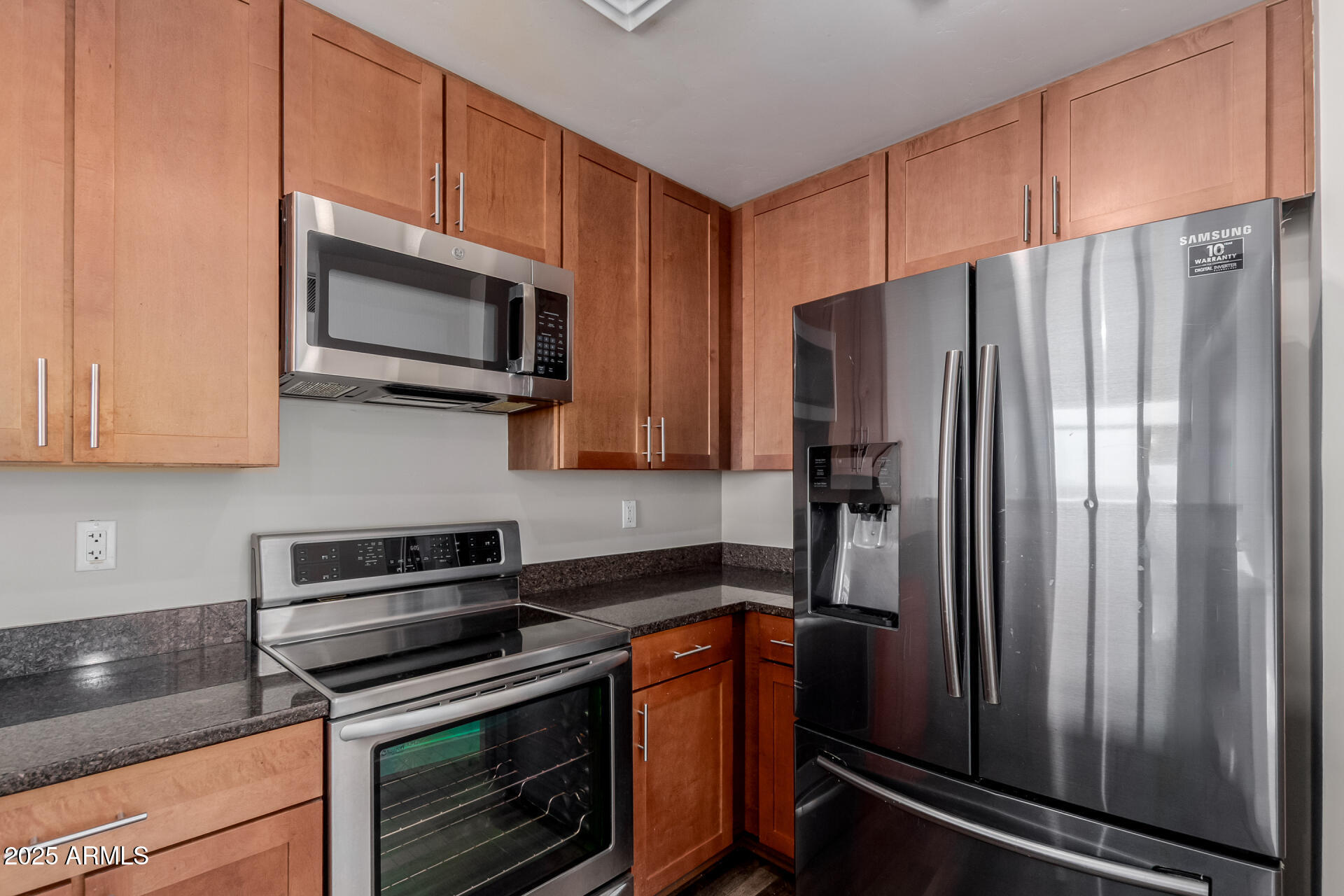 310 South 4th Street, Unit 1902 Phoenix, AZ 85004 - Photo 12 of 37 a kitchen with stainless steel appliances granite countertop a refrigerator stove and microwave