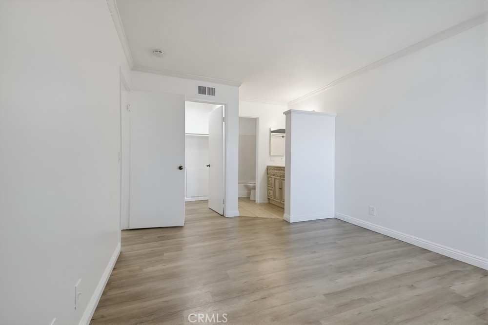 115 Remington Irvine, CA 92620 - Photo 14 of 25 a view of an empty room with wooden floor and closet