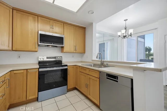 a kitchen with stainless steel appliances a stove sink and microwave
