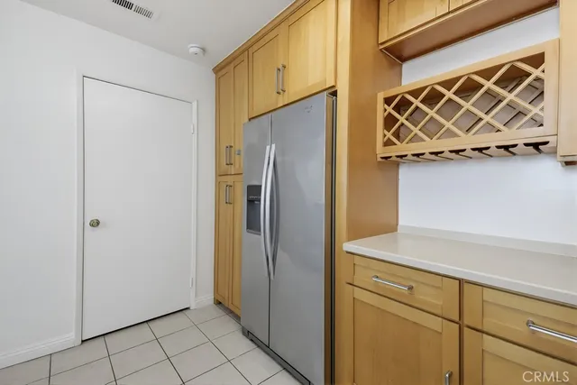 a view of a refrigerator and utility room