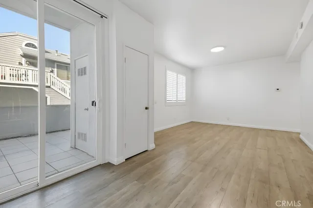 a view of an empty room with glass door