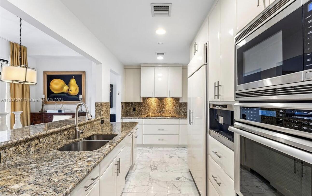 200 East Palmetto Park Road, Unit 16 Boca Raton, FL 33432 - Photo 2 of 4 a kitchen with stainless steel appliances granite countertop a sink a stove oven and granite counter tops