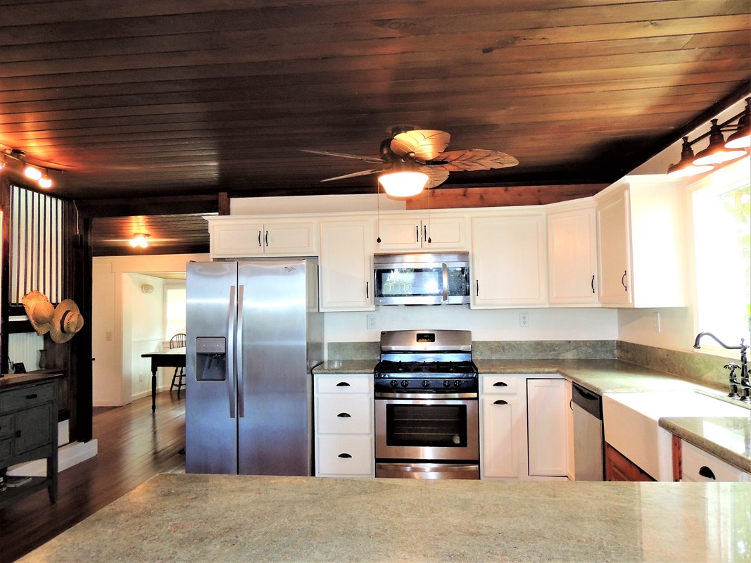 81-1073 Captain Cook Road, Unit A Captain Cook, HI 96704 - Photo 3 of 25 a kitchen with stainless steel appliances a refrigerator a sink a stove and cabinets