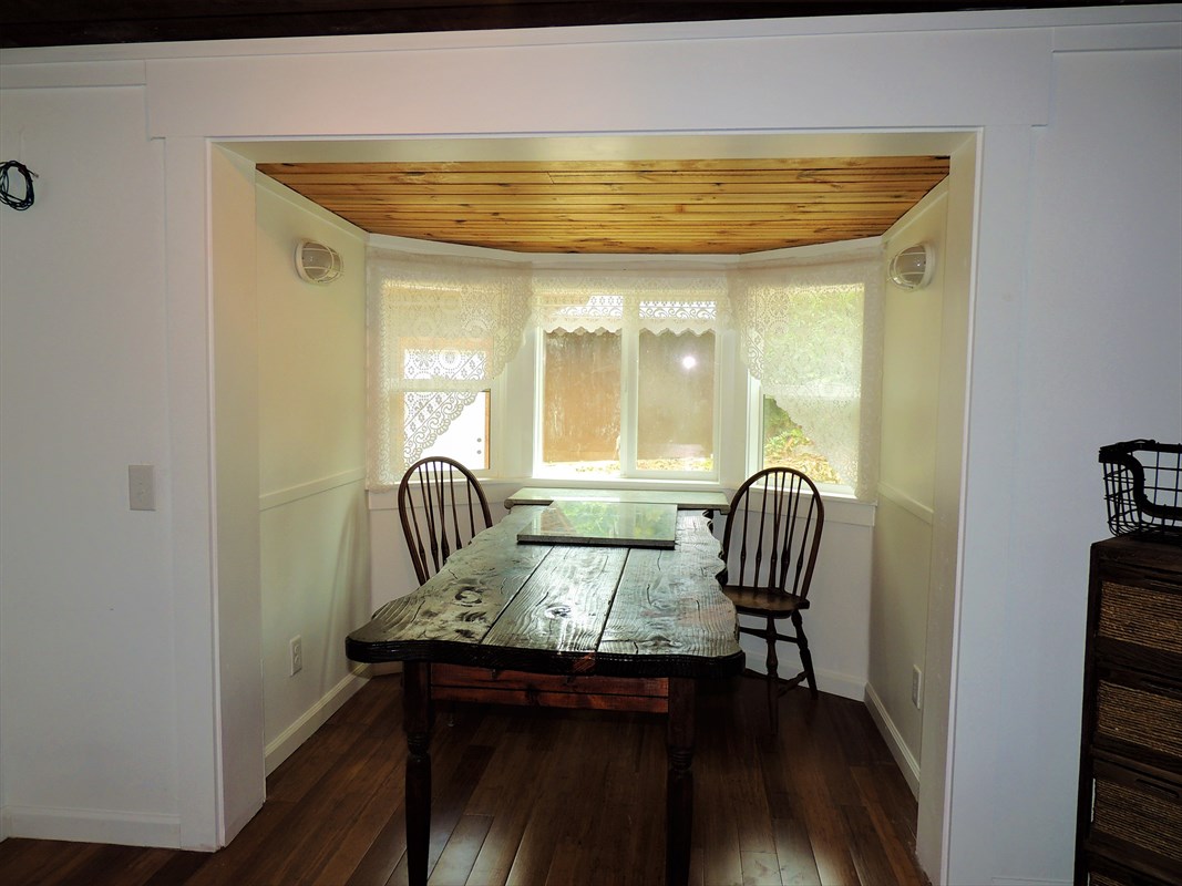 81-1073 Captain Cook Road, Unit A Captain Cook, HI 96704 - Photo 6 of 25 a view of a dining room with furniture and wooden floor