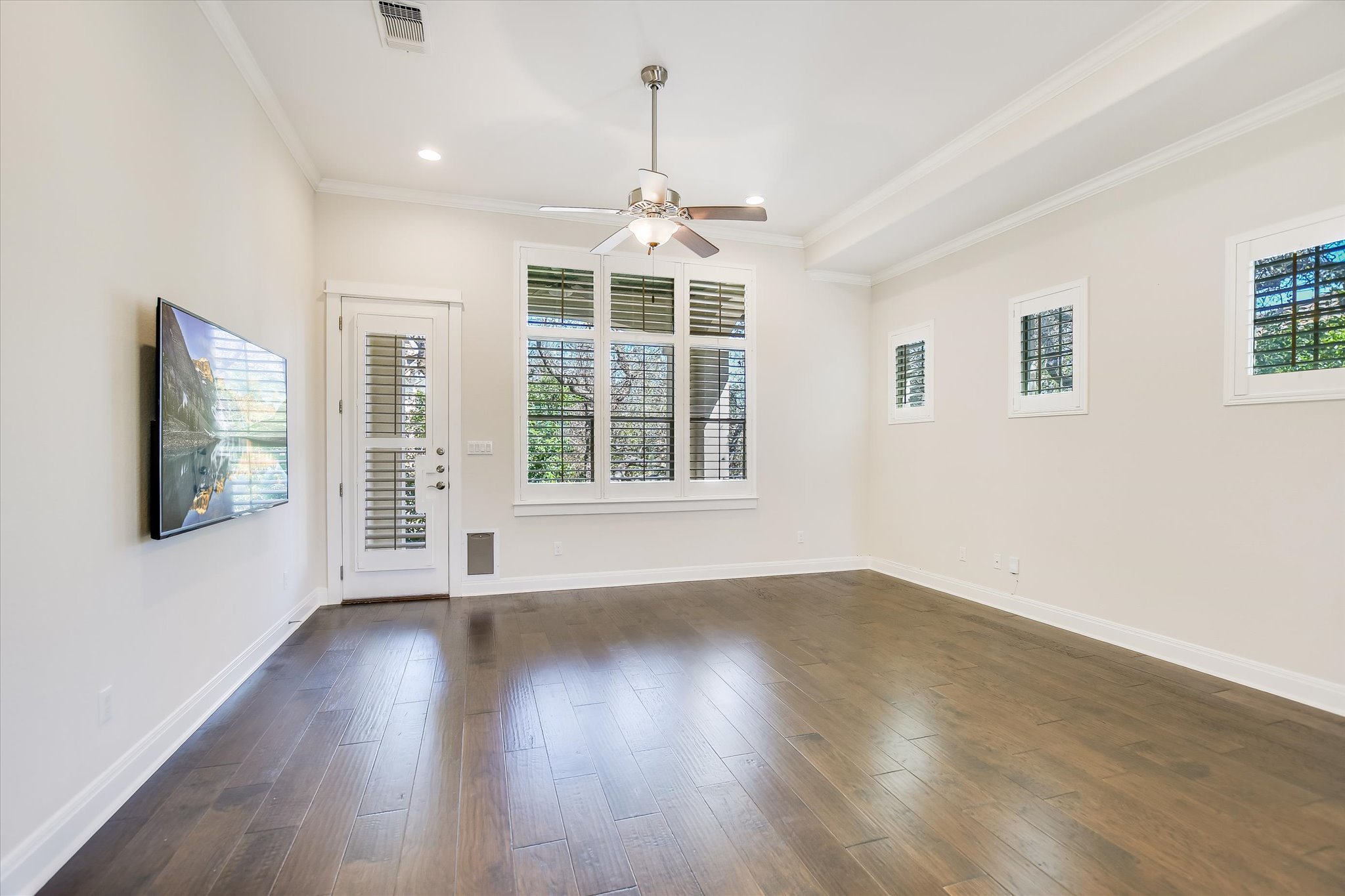 13510 Golden Wave Loop, Unit 53 Austin, TX 78738 - Photo 4 of 35 a view of an empty room with wooden floor and a window