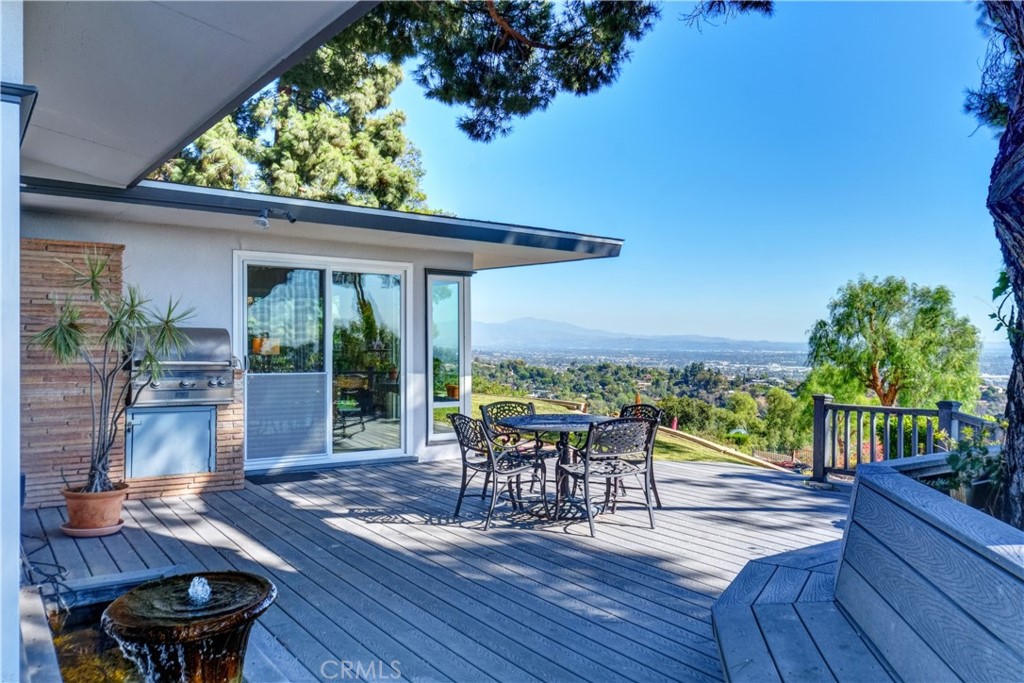 2182 Ahuacate Road La Habra Heights, CA 90631 - Photo 1 of 1 a roof deck with table and chairs potted plants with wooden floor